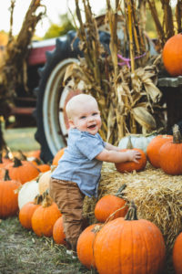 boy playing with pumpkins