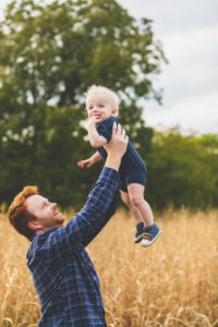 Dad holding son in the air