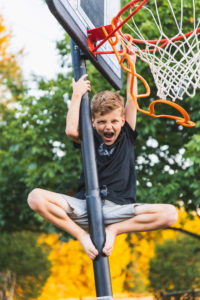 boy on a basketball hoop