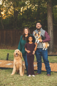 Family standing with dogs