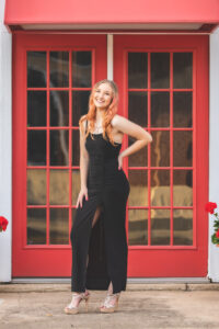 Girl in front of red doors